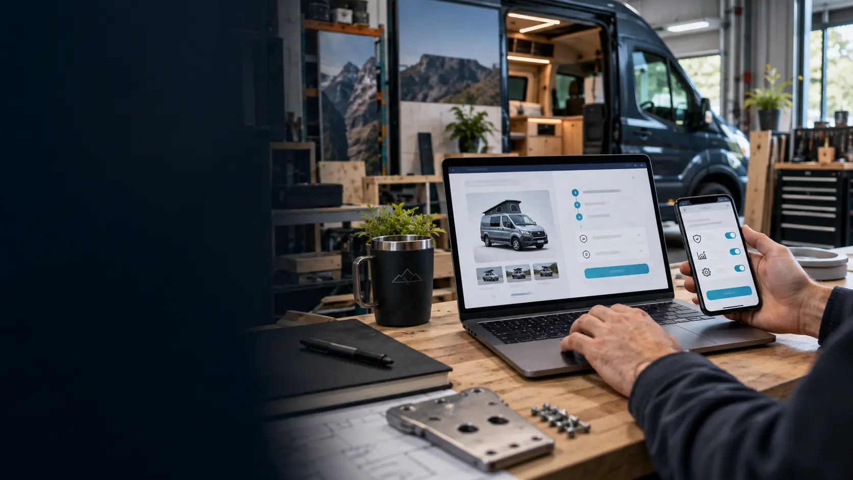 A secure campervan marketplace checkout displayed on a laptop and phone in a professional workshop.